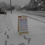 Footsteps and Open sign in snow outside church