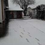 footsteps in snow leading up to the church door